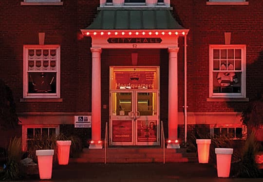 City hall building lit in red with permanent LED lighting